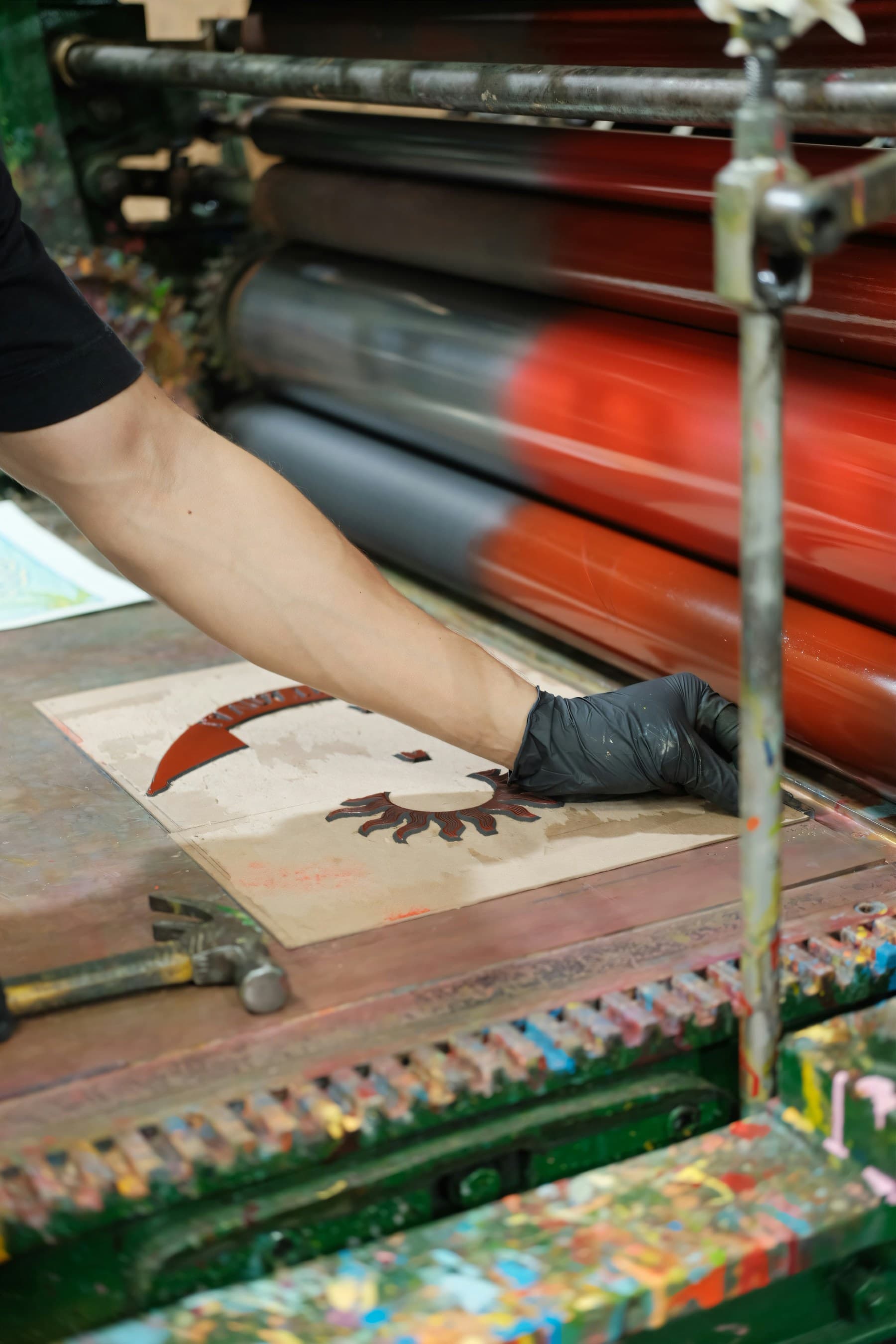 An artist applying ink to a printing plate